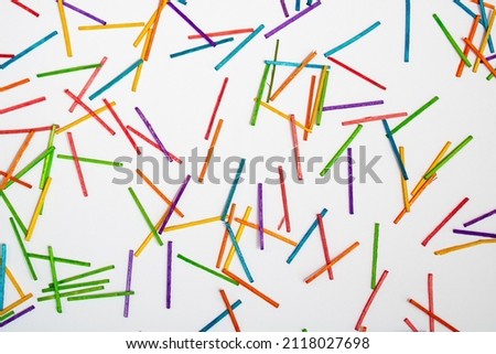 Wallpaper made of colorful sticks, red, blue, green, yellow, purple, orange, on clear white background. Minimal texture concept. Colors eliminate depression. Diversity out of order.