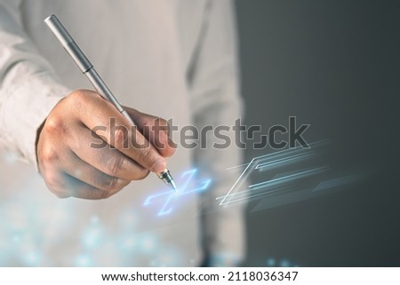 Health insurance concept. The man prepares a pen to sign online agreement. This shot was focus on the hand.