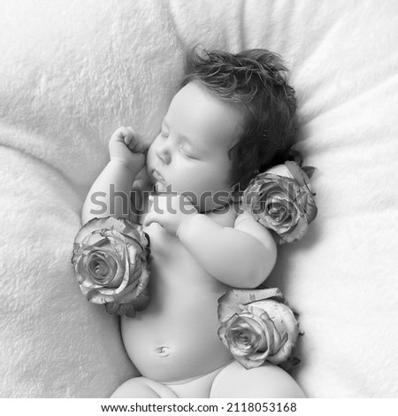 Portrait of a beautiful little baby girl with pink flowers. Healthy child, concept of hospital and happy motherhood. Infant baby. Healthy and medical concept. Happy pregnancy and childbirth