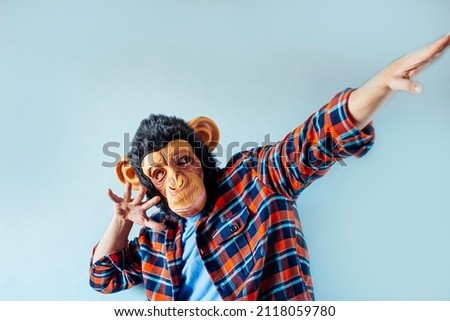 Man in monkey mask gesturing.
