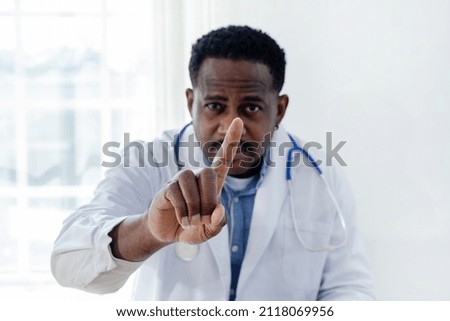 Close-up of an African Doctor Finger pressing the screen.