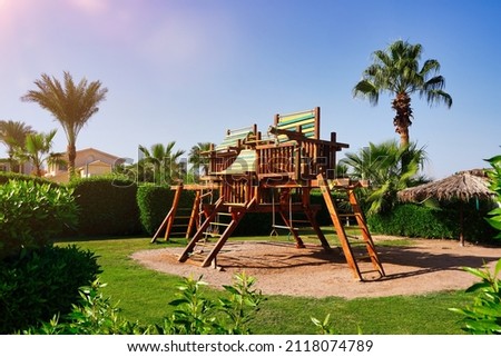 Wooden Playground with sand to develop and relax children. Summer holiday with sunshine