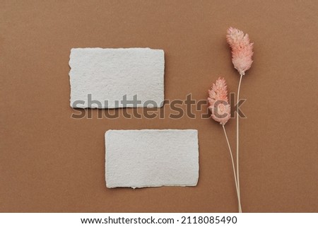 Still life scene with two blank business, greeting card, invitation mockup on brown background. Flat lay, top view.