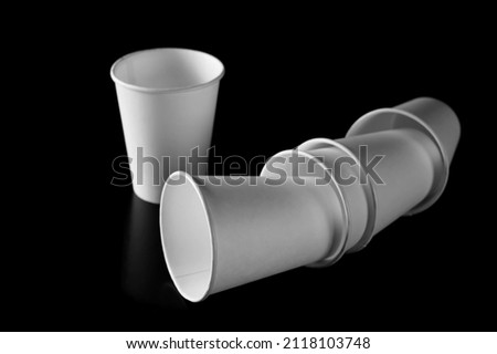 Disposable empty paper cups isolated on black background, clipping path