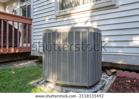 residential air conditioning unit with a new condenser unit has just been installed Royalty-Free Stock Photo #2118131492