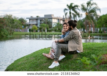 happy couple enjoying weekend and bonding in afternoon in front of lake Royalty-Free Stock Photo #2118136862