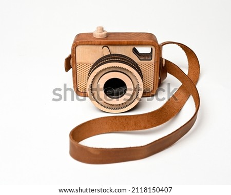 Wooden camera toy with strap isolated on white background