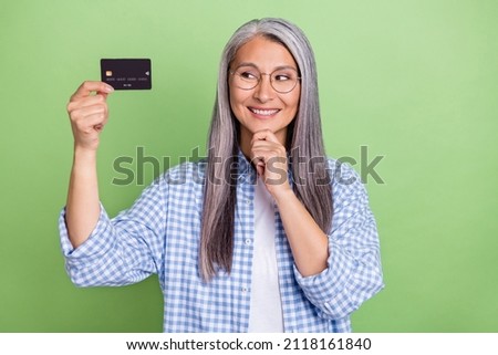 Photo of optimistic old grey hairdo lady look card wear eyewear plaid shirt isolated on green color background