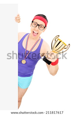 Basketball player holding a trophy behind a panel isolated on white background