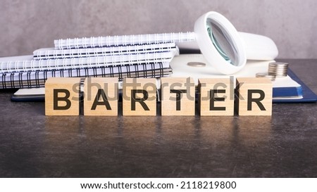 business concept - barter text on wooden blocks background. stock photo. gray backgrond