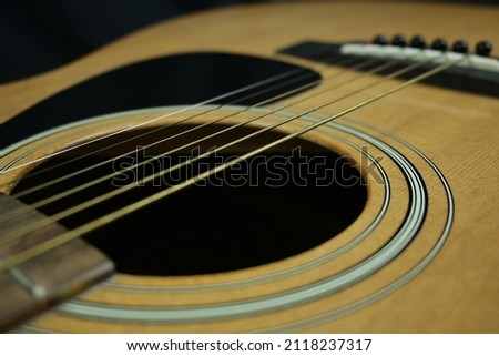 Acoustic guitar. The guitar is a stringed instrument that is played by picking