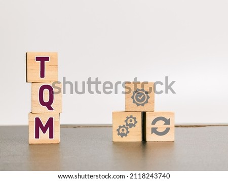 Total quality management concept with symbols on wooden cubes. Royalty-Free Stock Photo #2118243740