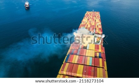 Stern of large cargo ship with Smoke exhaust gas emissions from cargo lagre ship ,Marine diesel enginse exhaust gas from combustion. Royalty-Free Stock Photo #2118273104