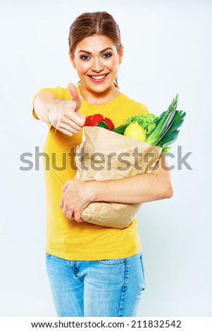 Smiling woman hold green food. Thumb up.White  Isolated Portrait.