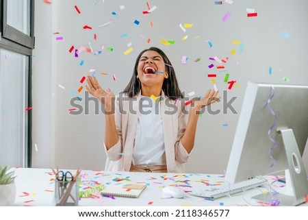 Young business woman having fun time catching confetti Royalty-Free Stock Photo #2118346577