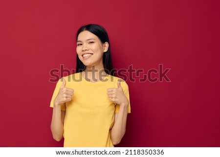 woman with Asian appearance yellow casual t shirt smile posing isolated background unaltered