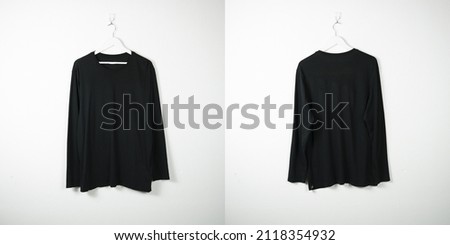 Clothes on a hanger, white wall background. 