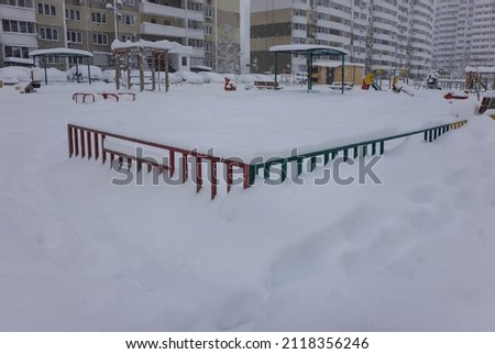 playground near the house covered with snow