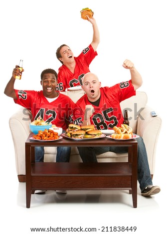 Fans: Guys Cheer Excitedly While On Couch With Food And Drink