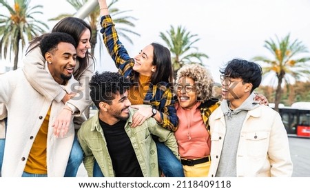 Multiracial group of friends bonding outside - Happy young people walking down the street laughing and having fun - Adult students hangout together in the city center - Friendship lifestyle concept Royalty-Free Stock Photo #2118409118