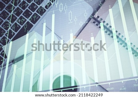 Stock market graph and top view computer on the table background. Double exposure. Concept of financial education.