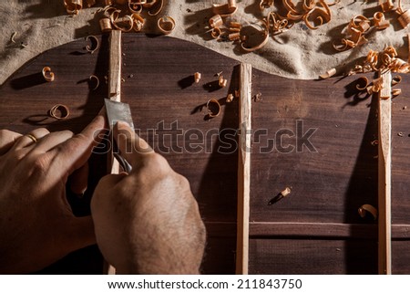 Luthier making top of guitar Royalty-Free Stock Photo #211843750