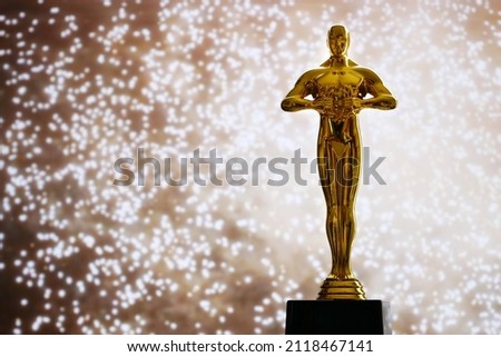 Hollywood Golden Oscar Academy award statue on fireworks background. Success and victory concept. Royalty-Free Stock Photo #2118467141
