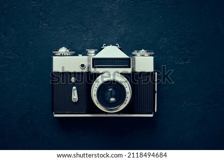 Old close up camera photo on dark background, vintage toning