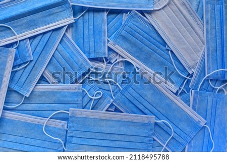 a large number of medical masks. lot of medical blue masks. means of protection. top view. macro photography.