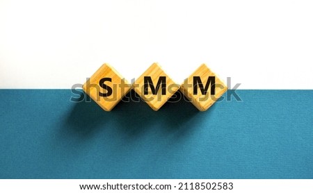 SMM, social media marketing symbol. Concept word SMM social media marketing on wooden cubes on beautiful white background, copy space. Business, SMM social media marketing concept.