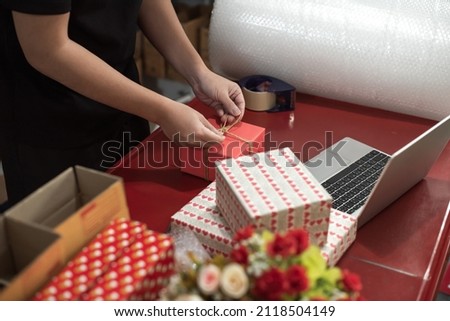 Paper art Valentine's day concept banner with hand made gift box. The concept of delivery of gifts and parcels for the holidays valentines day, pleasant surprises. man holding craft paper for delivery Royalty-Free Stock Photo #2118504149