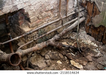 old sewer pipes in the apartment of a multi-storey residential building. A picture of the toilet, the toilet is dismantled. sewer riser 