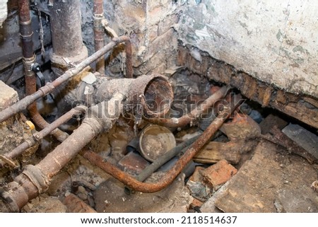 old sewer pipes in the apartment of a multi-storey residential building. A picture of the toilet, the toilet is dismantled. sewer riser 