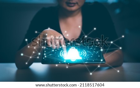 Woman Use your finger to press the button. Notification bell button on smartphone app screen close up,App Notification on Smart Phone Screen, Remote online alerts, home security signal. Royalty-Free Stock Photo #2118517604
