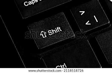 Shift key button on black background and texture 