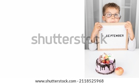 Banner of Funny adorable little boy in glasses with letter board. Education. 1 September. Back or First to school. Copy space. Banner