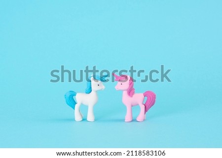 Love at first sight. A couple in love in pastel blue and pink unicorn on a blue background. Minimal concept of Valentine's Day, love, marriage.