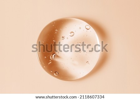 Cosmetic serum gel beauty oil drop on color background. Skin care product droplet with bubbles texture macro Royalty-Free Stock Photo #2118607334