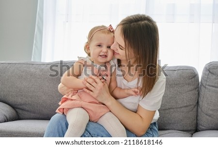 Happy family. Mother and baby daughter plays, hugging, kissing.