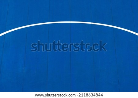 Blue volleyball, basketball, badminton, futsal, handball court. Wooden floor of sports hall with marking line on wooden floor indoor, gym court