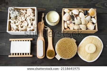 Flat lay.  On a wooden background are accessories for spa treatments, natural products made of wood and natural materials.  Seashells and corals in wooden boxes.  Zero waste concept.