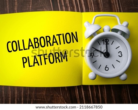 Top view clock and colored notebook with text COLLABORATION PLATFORM on wooden background