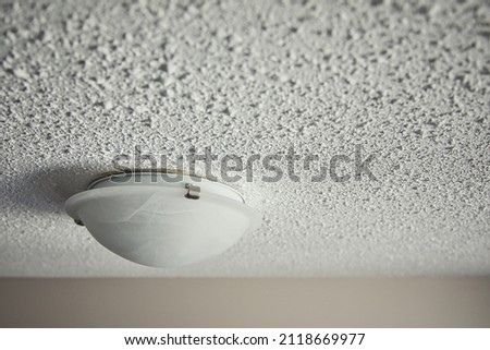 Popcorn Ceiling with lighting fixture Royalty-Free Stock Photo #2118669977