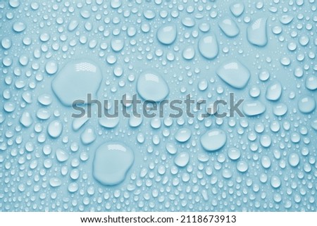 Cosmetic moisturizing liquid drops on blue pastel background. Toner or lotion. Hyaluronic serum Royalty-Free Stock Photo #2118673913
