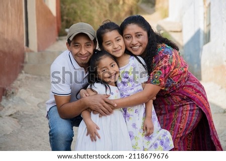 Portrait of a Latin family hugging in rural area - Happy Hispanic family in the village Royalty-Free Stock Photo #2118679676