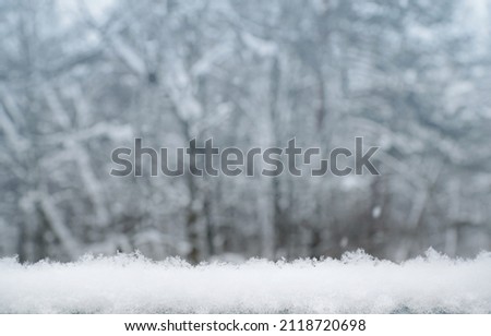 a layer of snow against the background of the forest. Winter background.