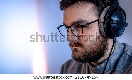 Portrait of a man with glasses and professional headphones.