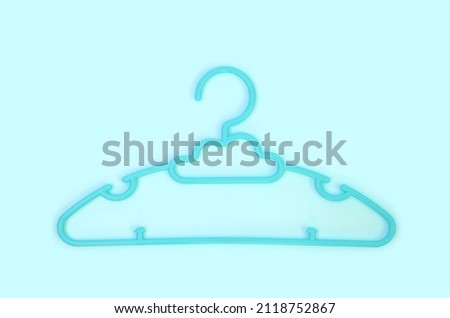 Cyan Plastic Clothes Hanger on blue sky background with Clipping path.