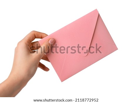 Woman hand holding pink envelope isolated on white background. Envelope with love declaration or congratulation on Valentines day. Valentines day concept. High quality photo