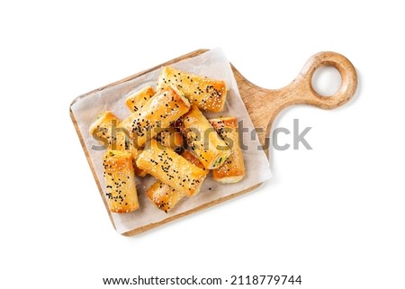 Turkish borek rolls with spinach and cheese. A traditional Turkish pastry rulo borek with black and white sesame seeds. Isolated on white background. top view Royalty-Free Stock Photo #2118779744